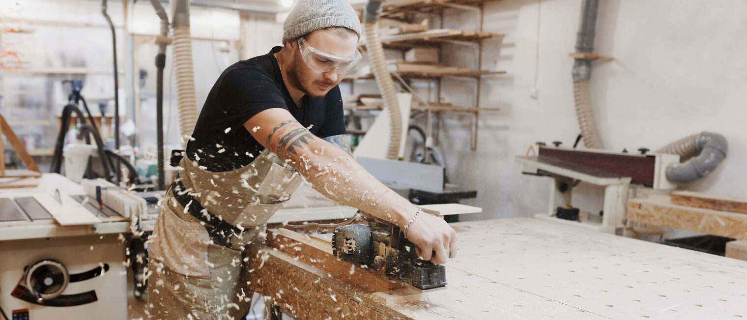 Junger Tischler arbeitet an der Werkbank
