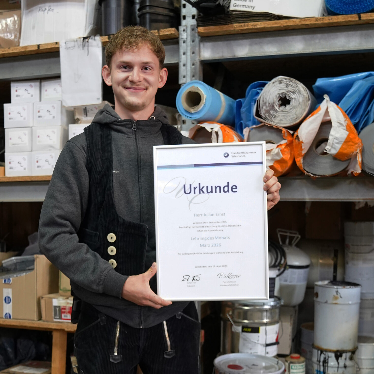 Julian Ernst mit seiner Urkunde zum Lehrling des Monats in der Werkshalle der Gottlieb Bedachung GmbH in Hohenstein. 